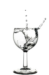 Water splash in wine glass isolated on white background.