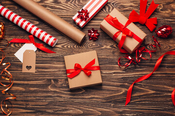 Gift wrapping for christmas and new year. Christmas background with gift boxes, ropes, paper handlebars and decorations on wooden background. Preparing for the holidays. Top view with copy space.