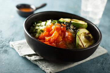 Healthy rice bowl with salmon and grilled avocado