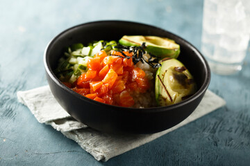 Healthy rice bowl with salmon and grilled avocado