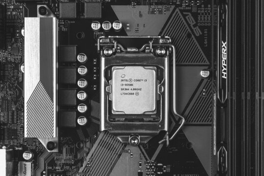 Maykop, Russia - November 9, 2018: intel core I3 desktop processor 8th gen and DDR 4 DIMM Kingston HyperX Fury Memory RAM Module in the slot on motherboard Asus closeup top view, black white photo