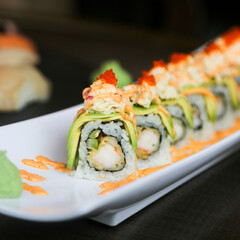 Delicious shrimp avocado sushi roll on a plate