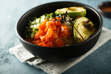 Healthy rice bowl with salmon and grilled avocado