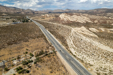 beautiful scenic aerial picture of highway and mountain landscape on cloudy day
