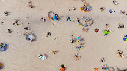 a beach in Poland on the Baltic Sea with tanning and vacationing people behind a screen view from the top