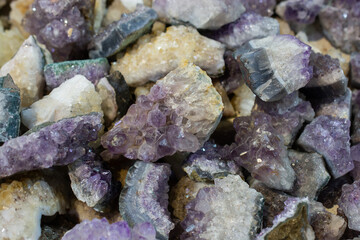 Heap of differently colored raw mineral marble fluorite stones