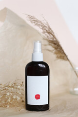 Eco friendly Bottle or jar with natural skincare cosmetics, creams or oils on light background. Plant-based beauty products