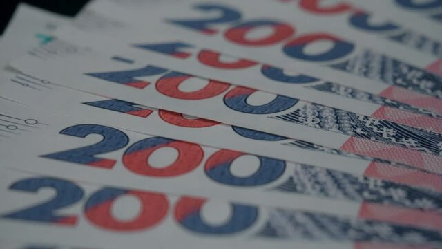 Ukrainian banknotes of two hundred hryvnia slowly rotate closeup. Macro view