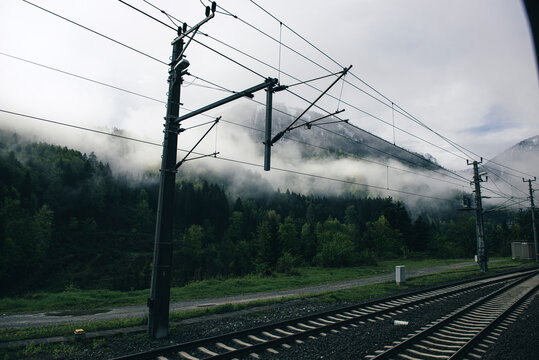 Railroad railway train tracks forest mountain city village town rural central 