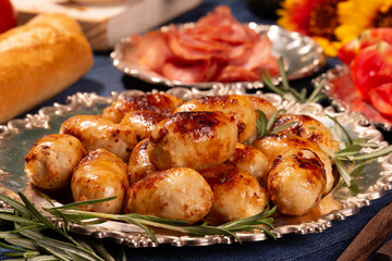 Delicious hot fried sausages and other food on the table