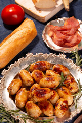 Delicious hot fried sausages and other food on the table