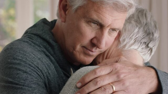 mature man hugging sad wife sharing bad news couple embracing stressful retirement marriage problems 4k footage