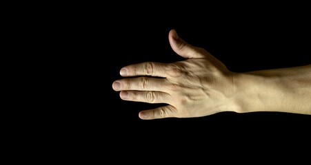 One hand with an open palm, isolated on black background. Caucasian or Mediterranean white skin.