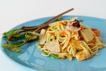 Green papaya salad with morning glory in ceramic blue plate isolated on white background.