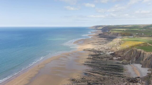 hyperlapse drone sunny summer day ocean and clouds Bude beach Cornwall