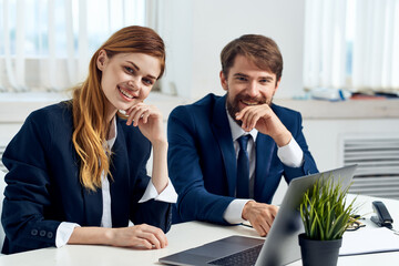 business man and woman work together in front of laptop office technology