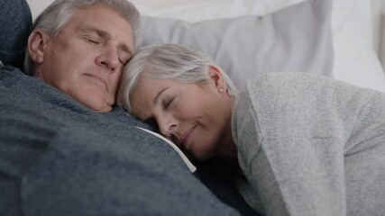 happy mature couple lying in bed cuddling together resting feeling tired enjoying relaxing comfortable at home peaceful retirement 4k footage - Powered by Adobe