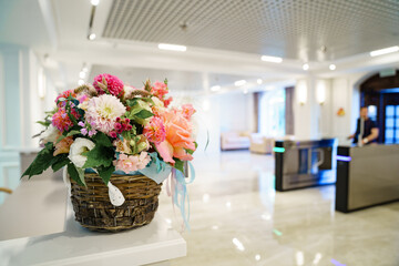 bouquet of flowers in hall . large classic wooden door. entrance and turnstile 