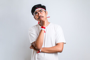 man wearing red and white headband thinking worried about a question