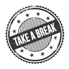 TAKE A BREAK text written on black grungy round stamp.
