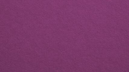 The surface of violet cardboard. Paper texture with cellulose fibers. Background with bright expressive tint. Paperboard wallpaper. Textured backdrop. Top-down. Macro
