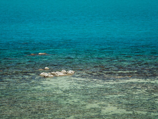 Koh Samui Island, Thailand. High angle view of scenic crystal clear turquoise sea water at peaceful rocky bay. Minimal background with copy space.