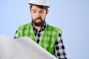 male worker in a white helmet blueprints Professional isolated background