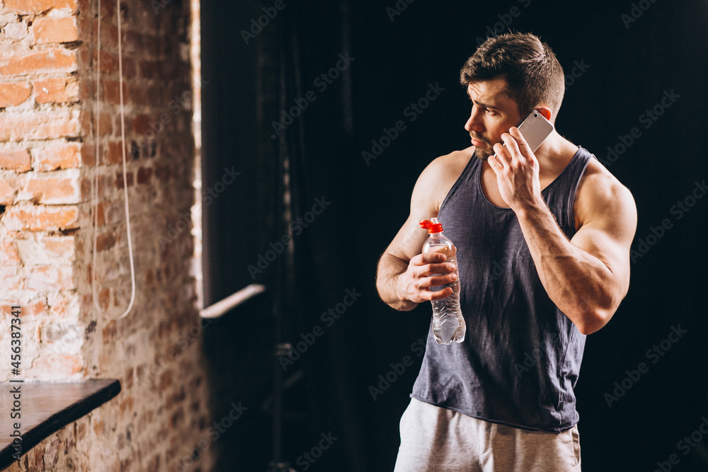 Sticker Fit man talking on the phone at the gym