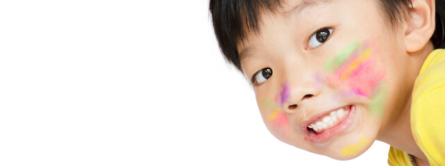 The Asian little boy smiled and had a smear of watercolor paint on his face on white background...
