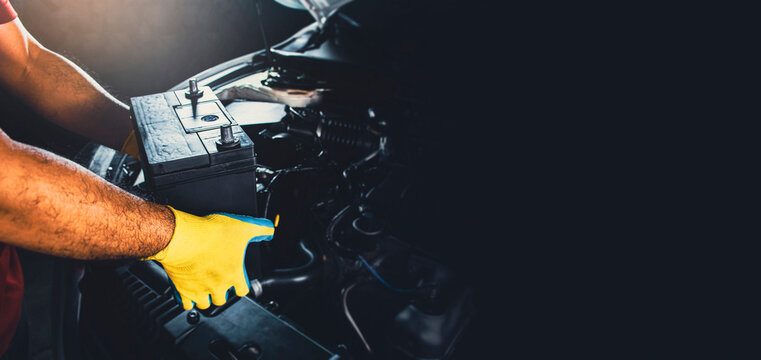 Technician replaced new battery of the car with copy space