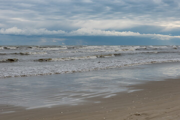 Winter seashore with clouds and waves