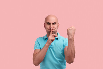 Tss, stop the noise. Anxious bald homosexual man with bristle is asking to keep silence, keeps...