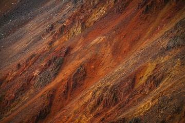 Scenic nature background of multicolor mountain. Colorful nature backdrop of motley rocks. Multicolor great rocks of vivid colors. Beautiful red orange rufous golden rocks. Closeup of motley mountain.