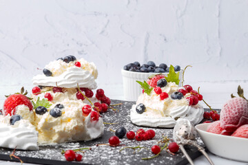 Anna Pavlova cake with currants, blueberries and strawberries
