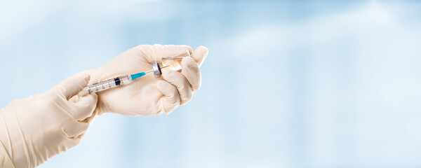 Hand holding viol with vaccine against corona virus.