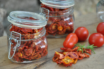Sun-dried tomatoes with herbs in a glass jar on a wooden background. Sun-dried Italian tomatoes.
Freeze-dried vegetables. Dried spices healthy food. Spices.