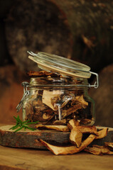 Dried mushrooms in a glass jar on a wooden background. Freeze-dried vegetables. Dried spices healthy food. Spices.