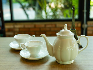 teapots on a wooden table in a coffee shop.