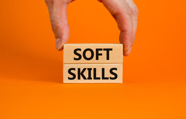 Soft skills symbol. Concept words 'Soft skills' on wooden blocks on a beautiful orange background....