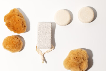 Yellow Natural bath or cleaning three sea sponges, dray shampoo, exfoliating body strap and pumice stone with strap on white background