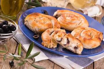 Pastry swirls with cheese and olive filling.