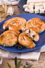 Pastry swirls with cheese and olive filling.