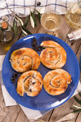 Pastry swirls with cheese and olive filling.
