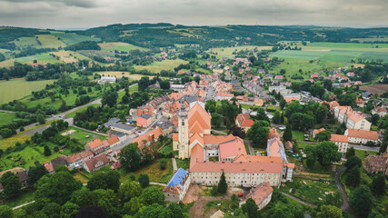 Fototapeta na wymiar Aerial photo of a typical Polish hosing estate in the mountains towns, taken on a sunny part cloudy day using a drone, showing the housing estate and farmers fields.