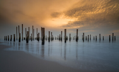 Long exposure of the north sea in petten, Netherlands. In the sea are a lot of polen. The skye is a nice orange collor.