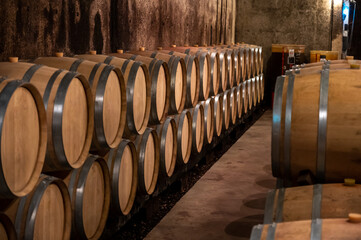 Keeping for years of dry red wine in new oak barrels in caves in Burgundy, made from pinot noir grape