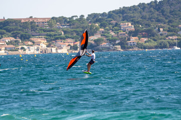 Hyeres, Almanarre beach, France, July 10, 2021. Extreem water sport - wing foil, kite surfing, wind surfindg, windy day on Almanarre beach near Toulon, South of France