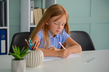 back to school. little girl student doing homework on a laptop. distance learning concept