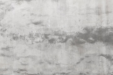 Shabby wall of an old house with uneven crumbling plaster. Yellow-gray abstract texture.