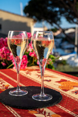 Romantic wedding party with two glasses of white cold champagne and view on yachts and houses of Port Grimaud, French riviera, France